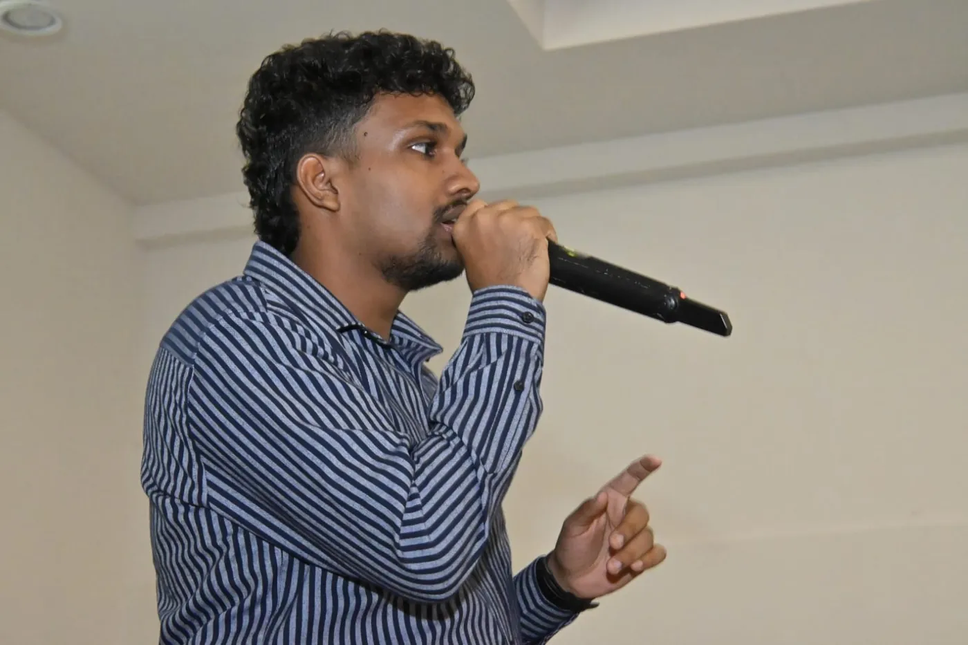 Nimuthu speaking into a microphone