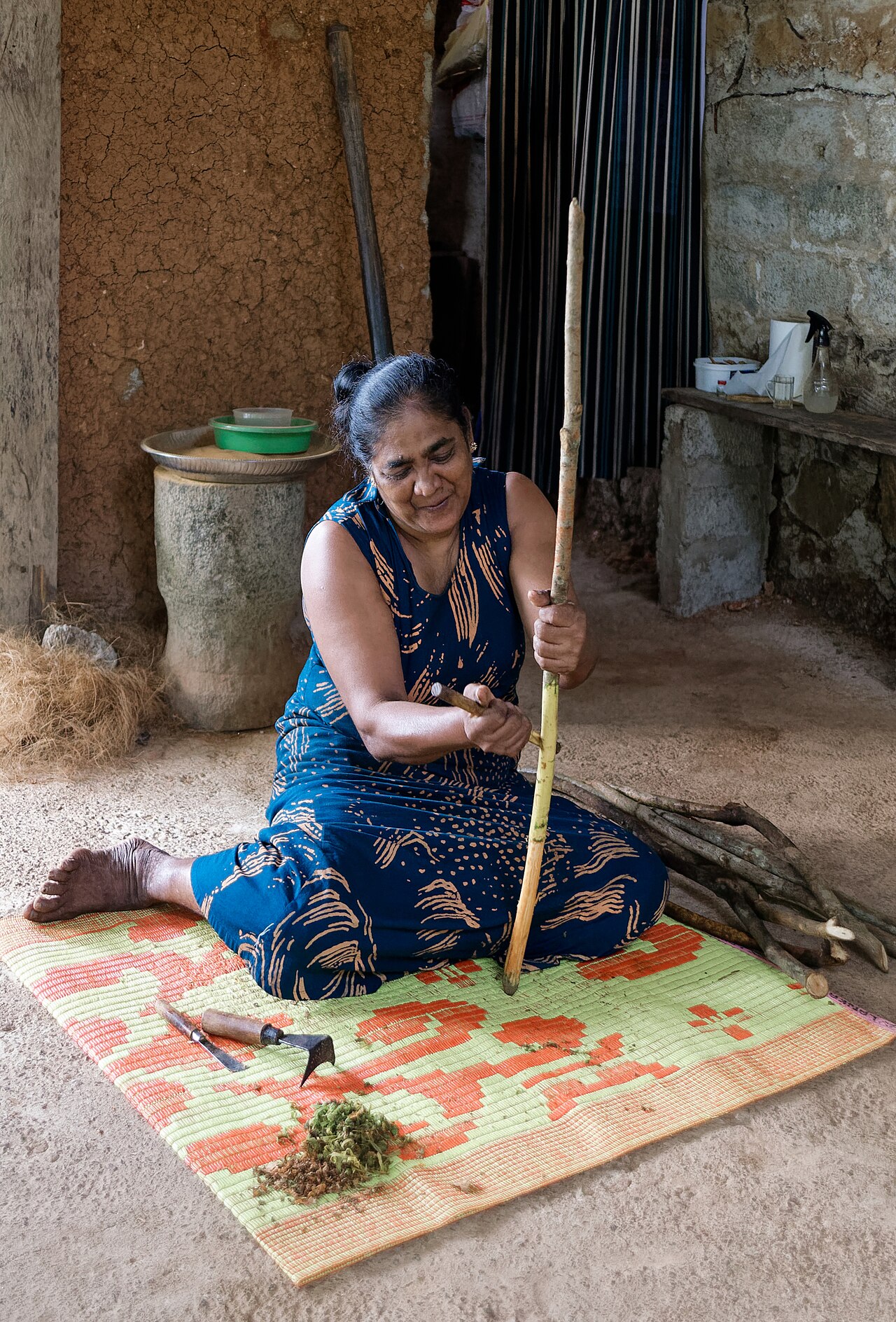 A cinnamon peeler preparing bark by hand in Balapitiya